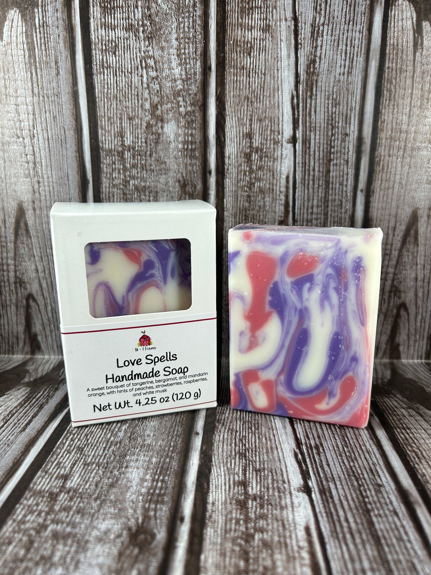 Colorful swirled soap bar with a label on a wooden surface
