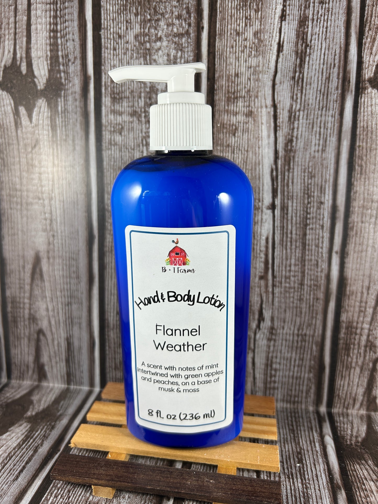 Hand and body lotion bottle on a wooden surface. Scent is called Flannel Weather