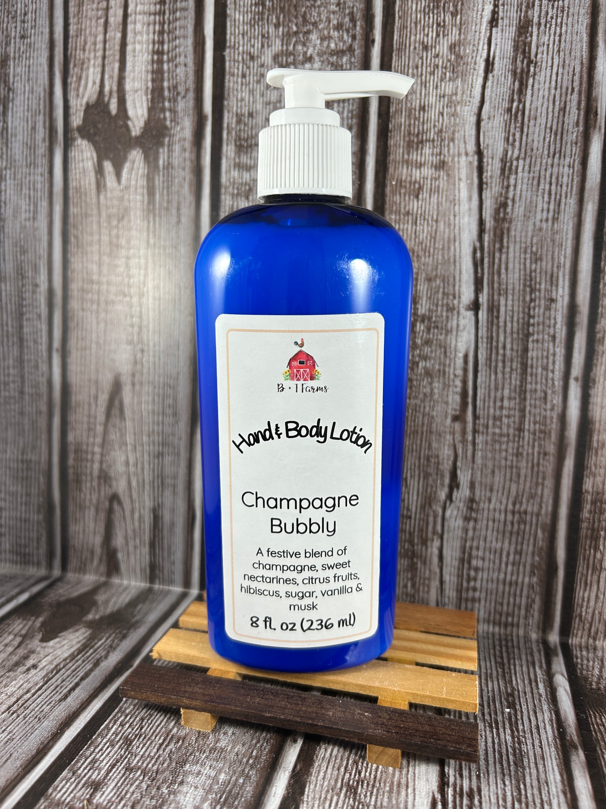 Hand and body lotion bottle on a wooden surface. Scent is called Champagne Bubbly