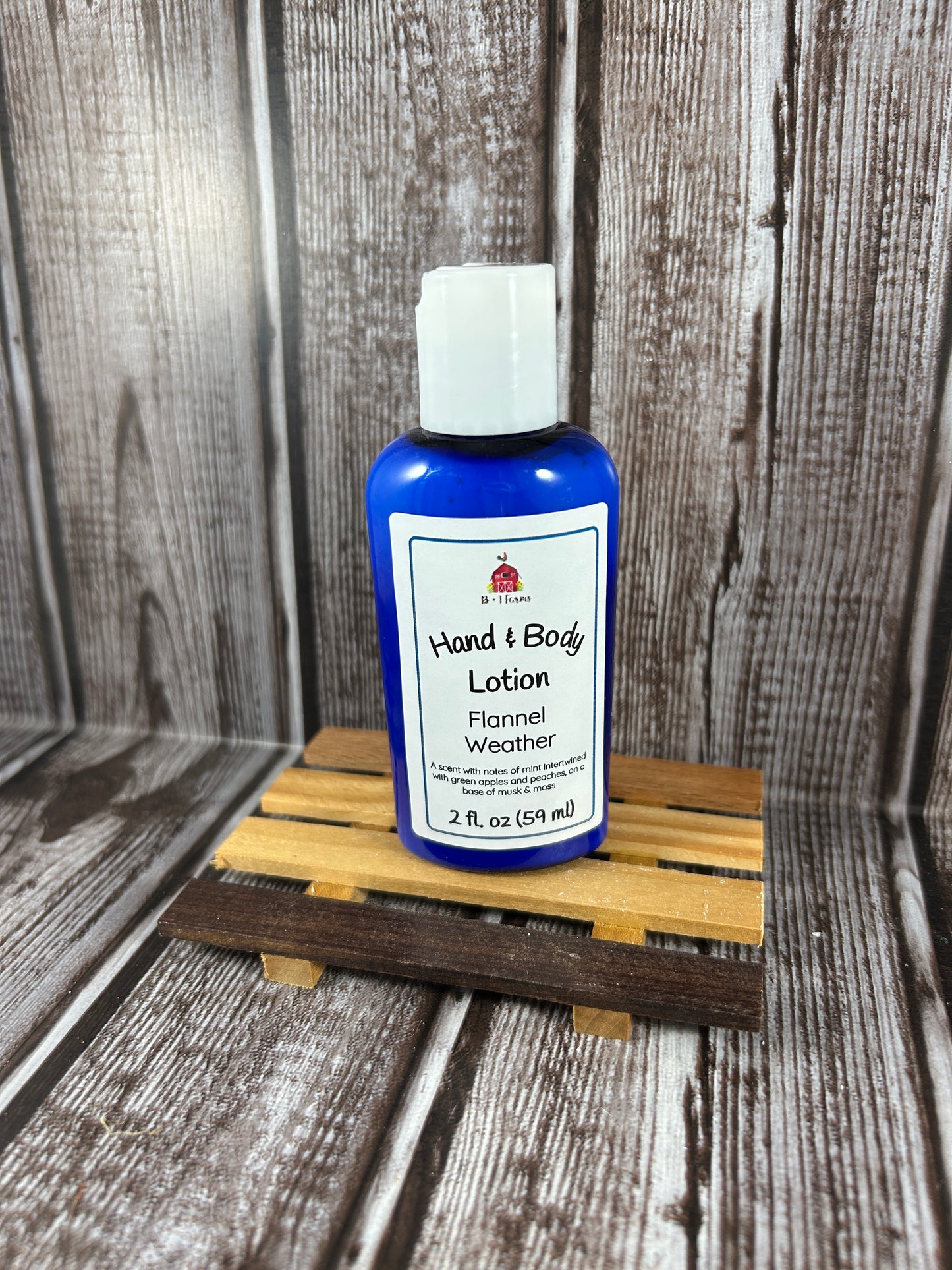 Hand and body lotion bottle on a wooden surface. Scent is called Flannel Weather