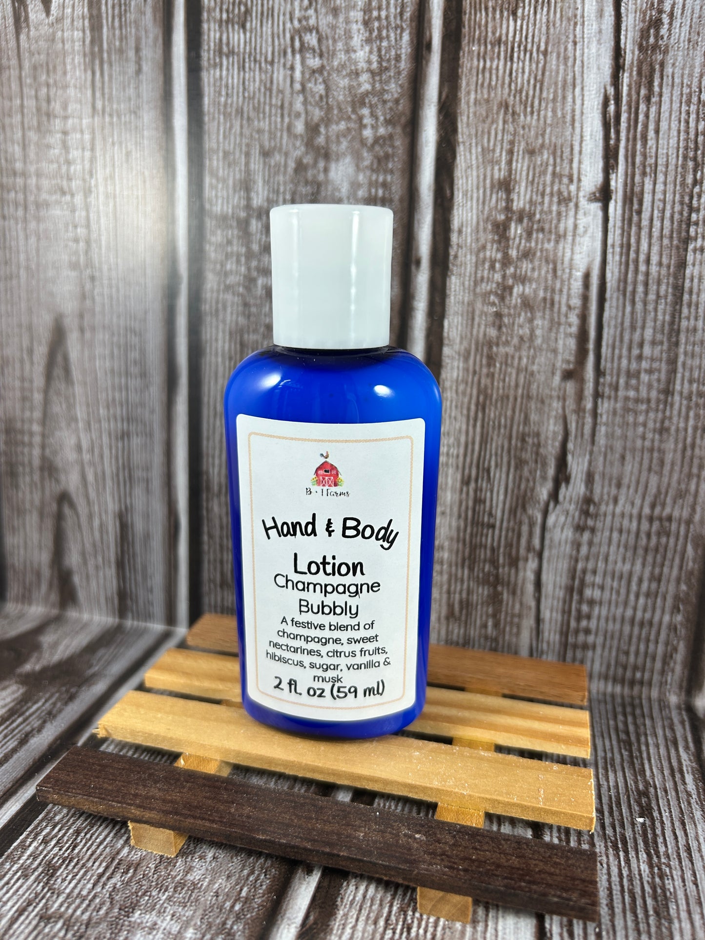 Hand and body lotion bottle on a wooden surface. Scent is called Champagne Bubbly