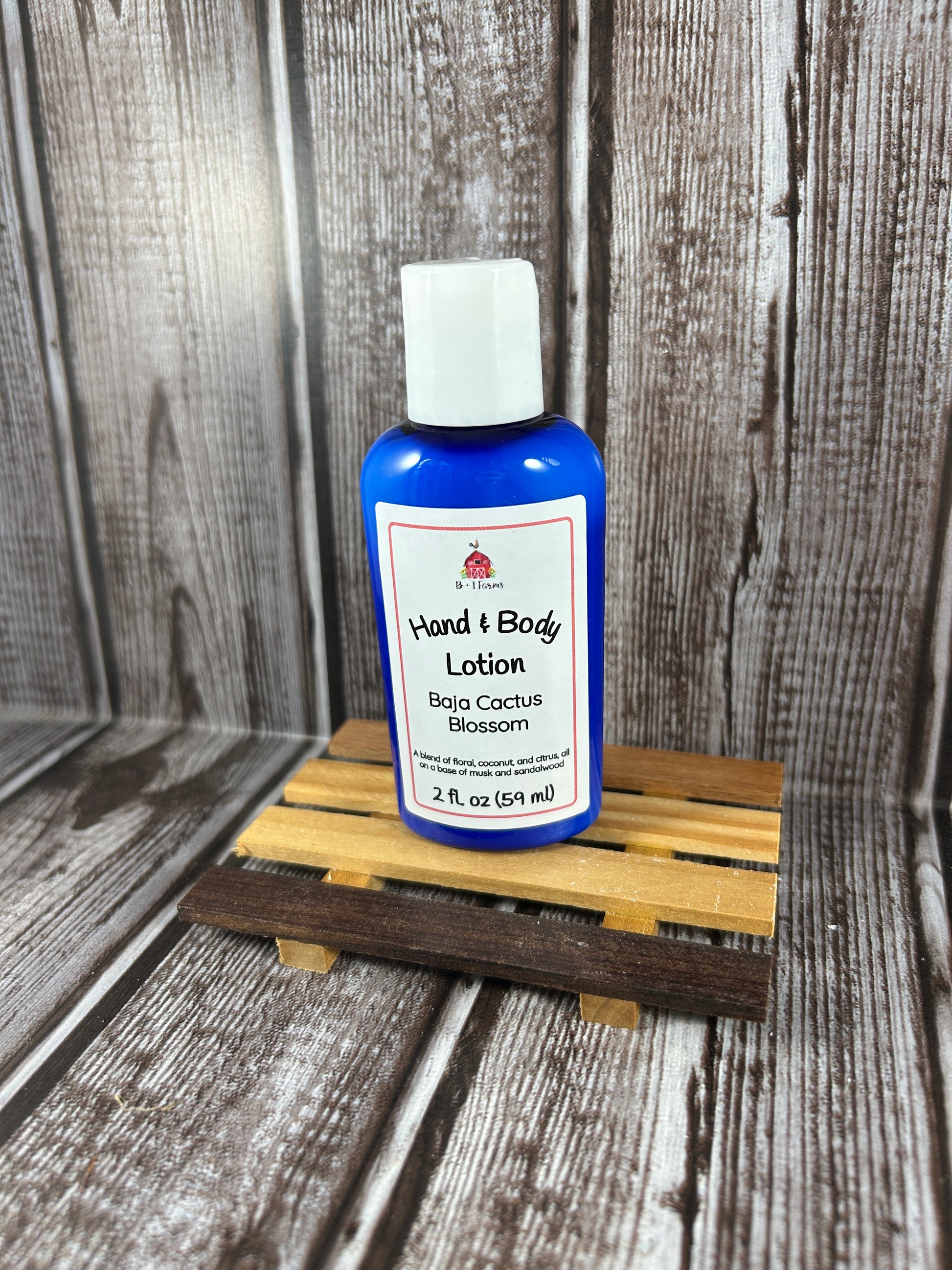 Hand and body lotion bottle on a wooden surface. Scent is called Baja Cactus Blossom