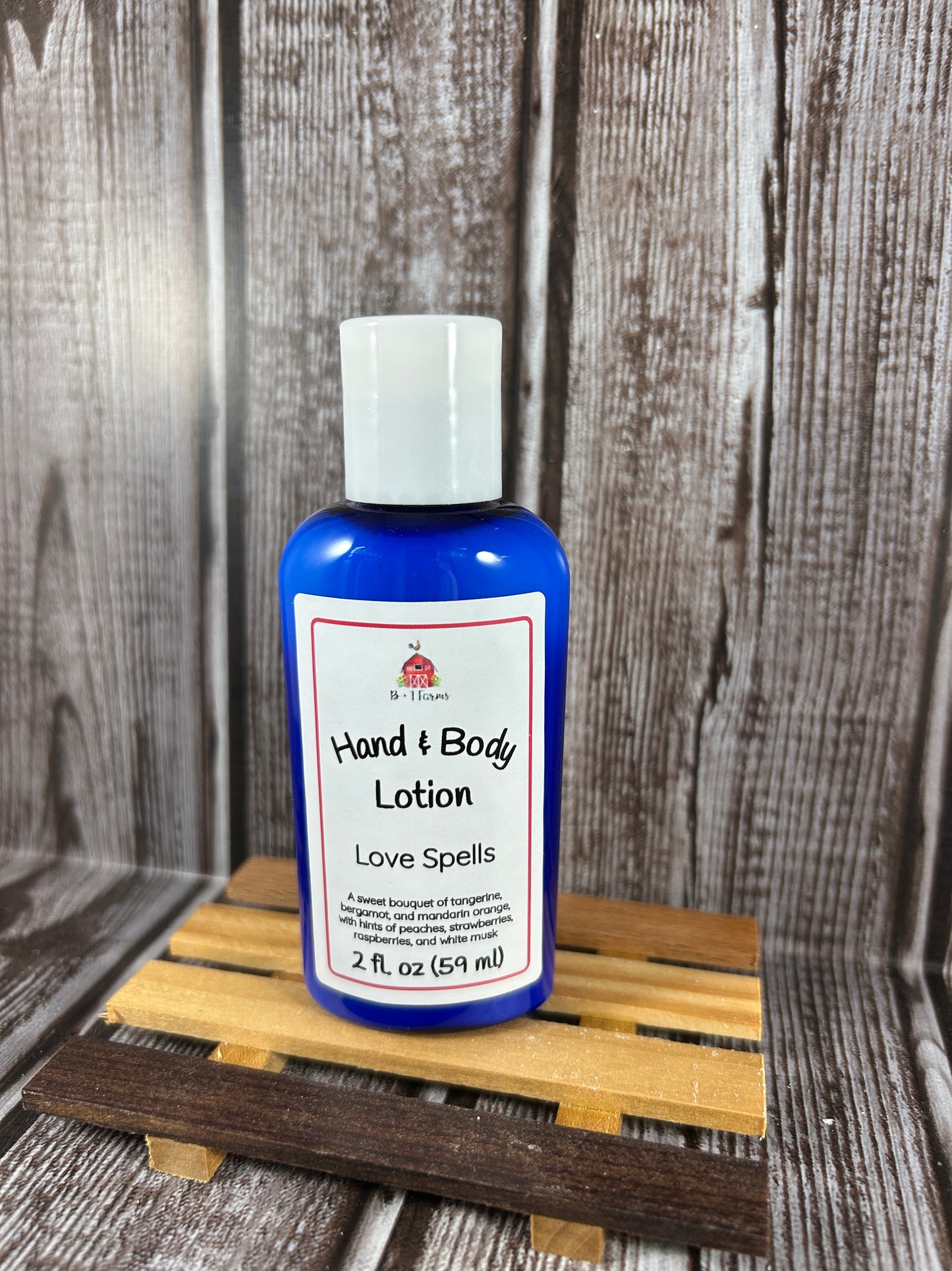 Hand and body lotion bottle on a wooden surface. Scent is called Love Spells