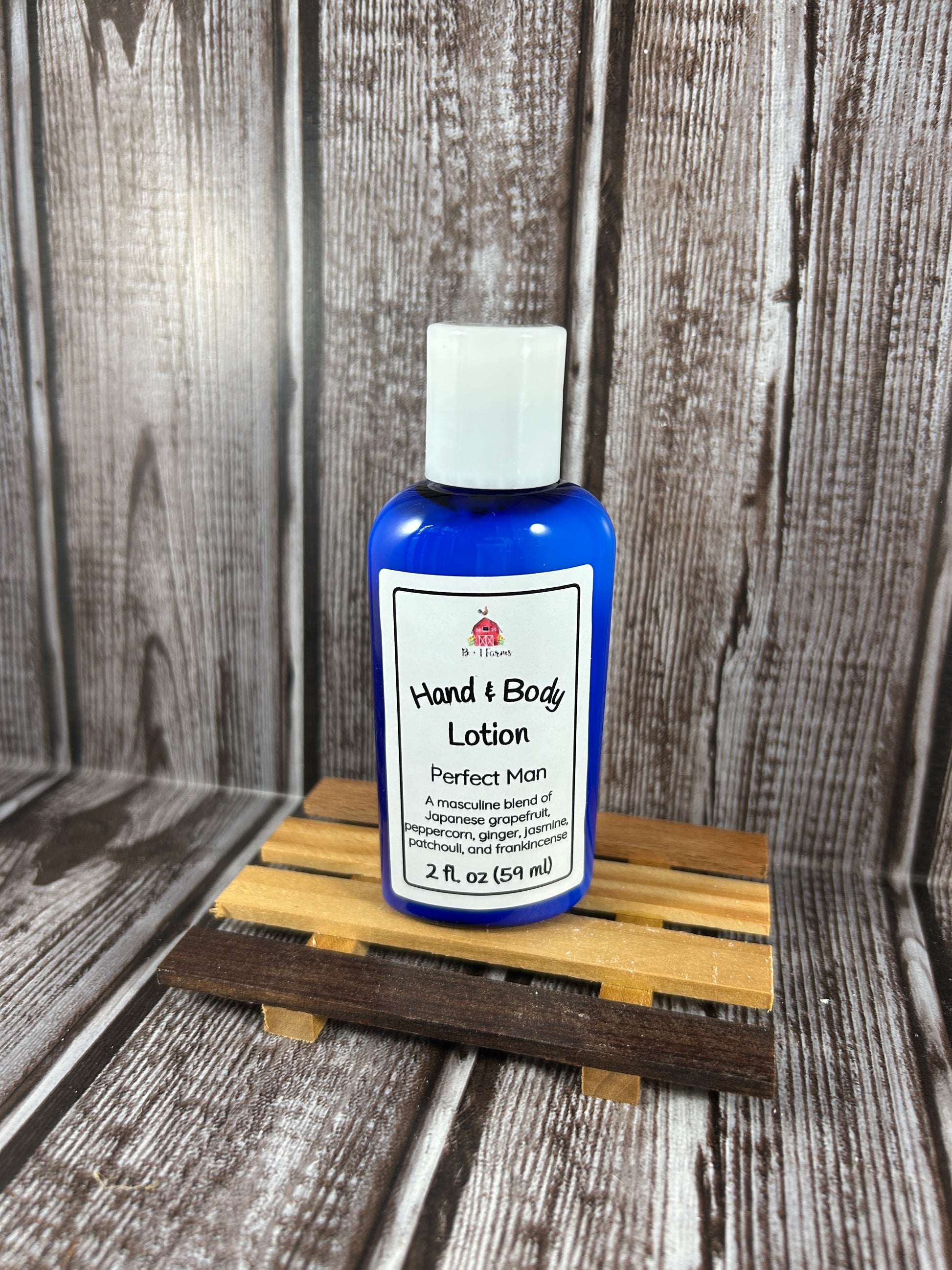 Hand and body lotion bottle on a wooden surface. Scent is called Perfect Man