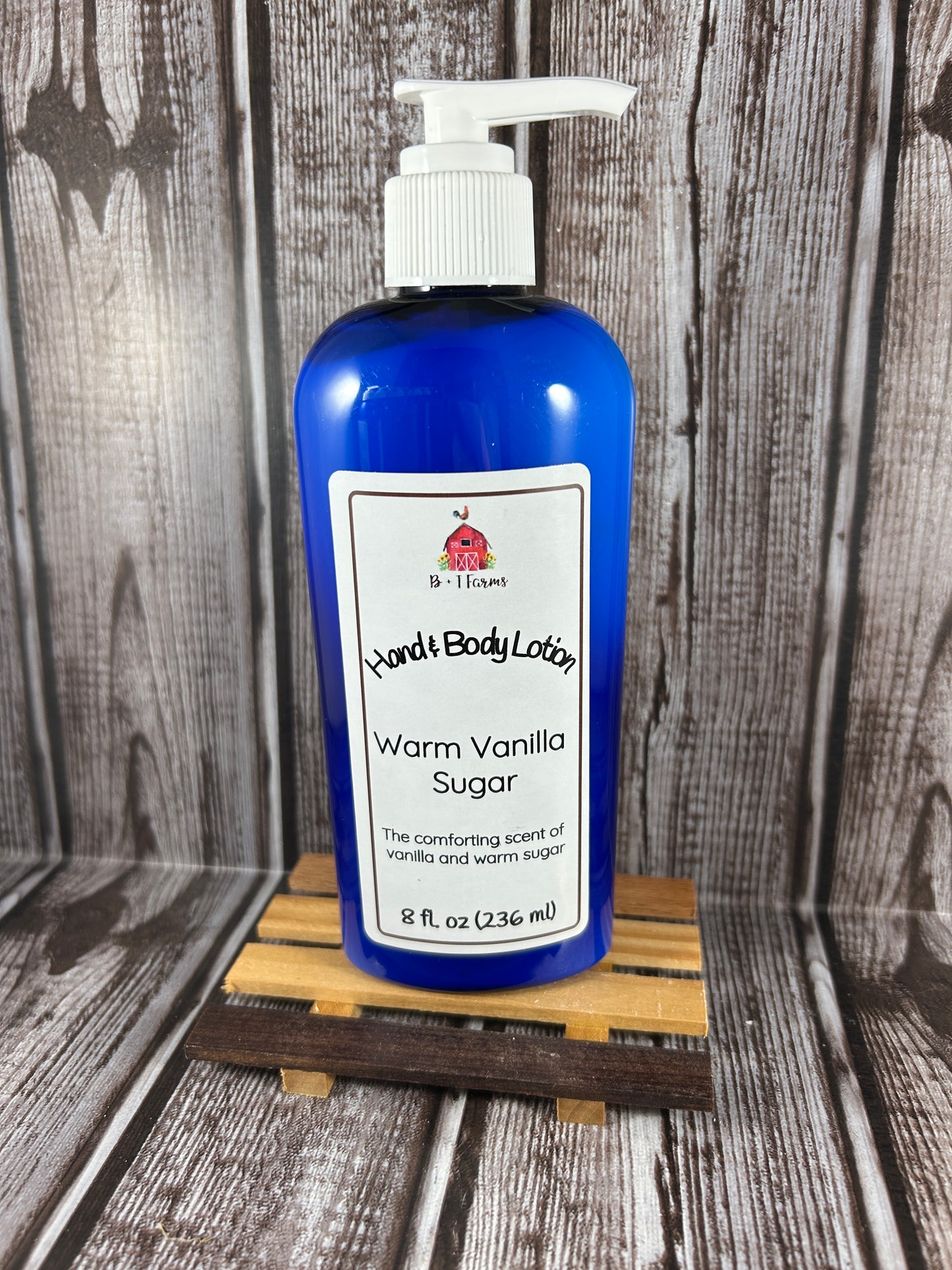 Hand and body lotion bottle on a wooden surface. Scent is called Warm Vanilla Sugar