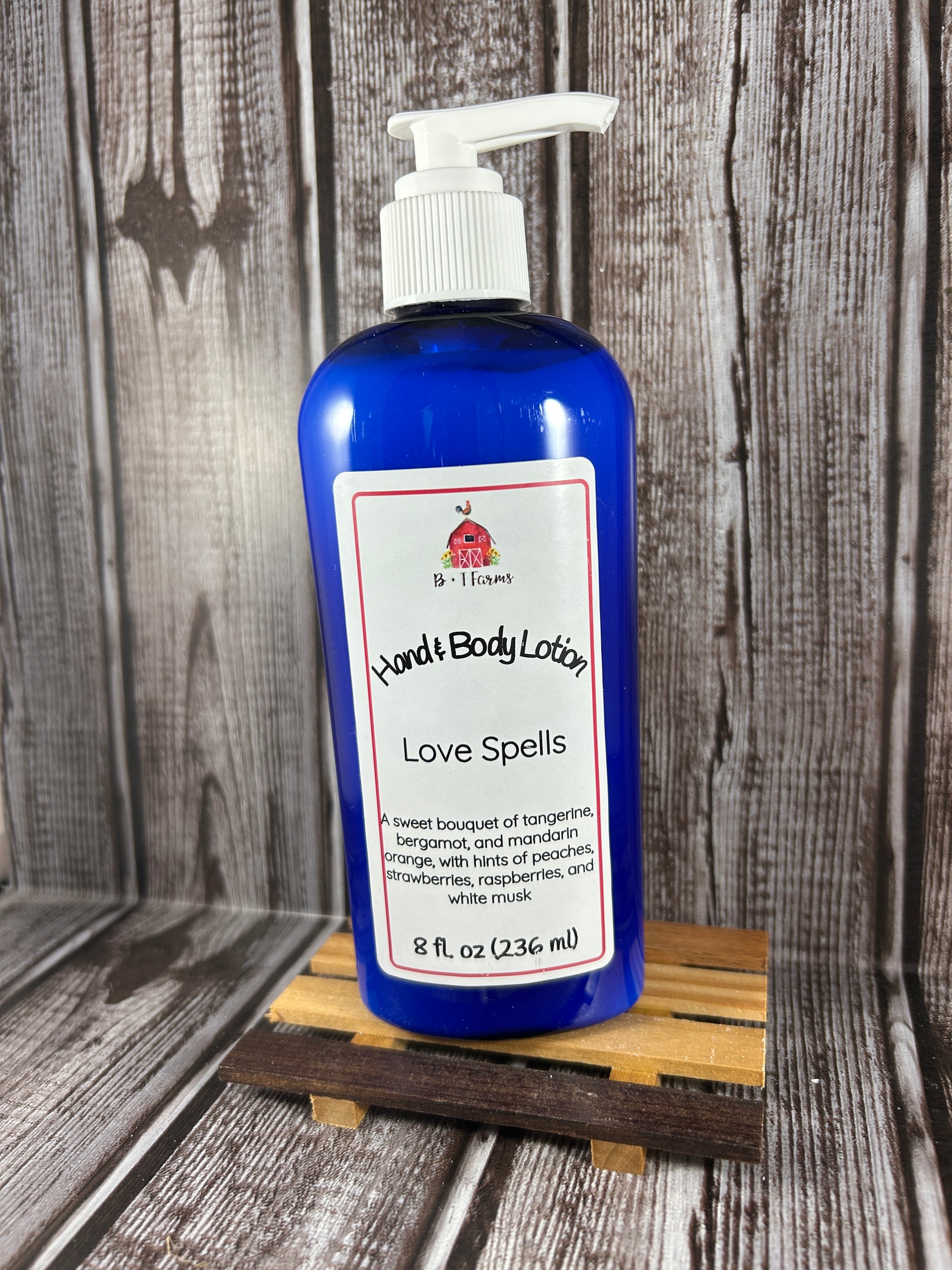 Hand and body lotion bottle on a wooden surface. Scent is called Love Spells