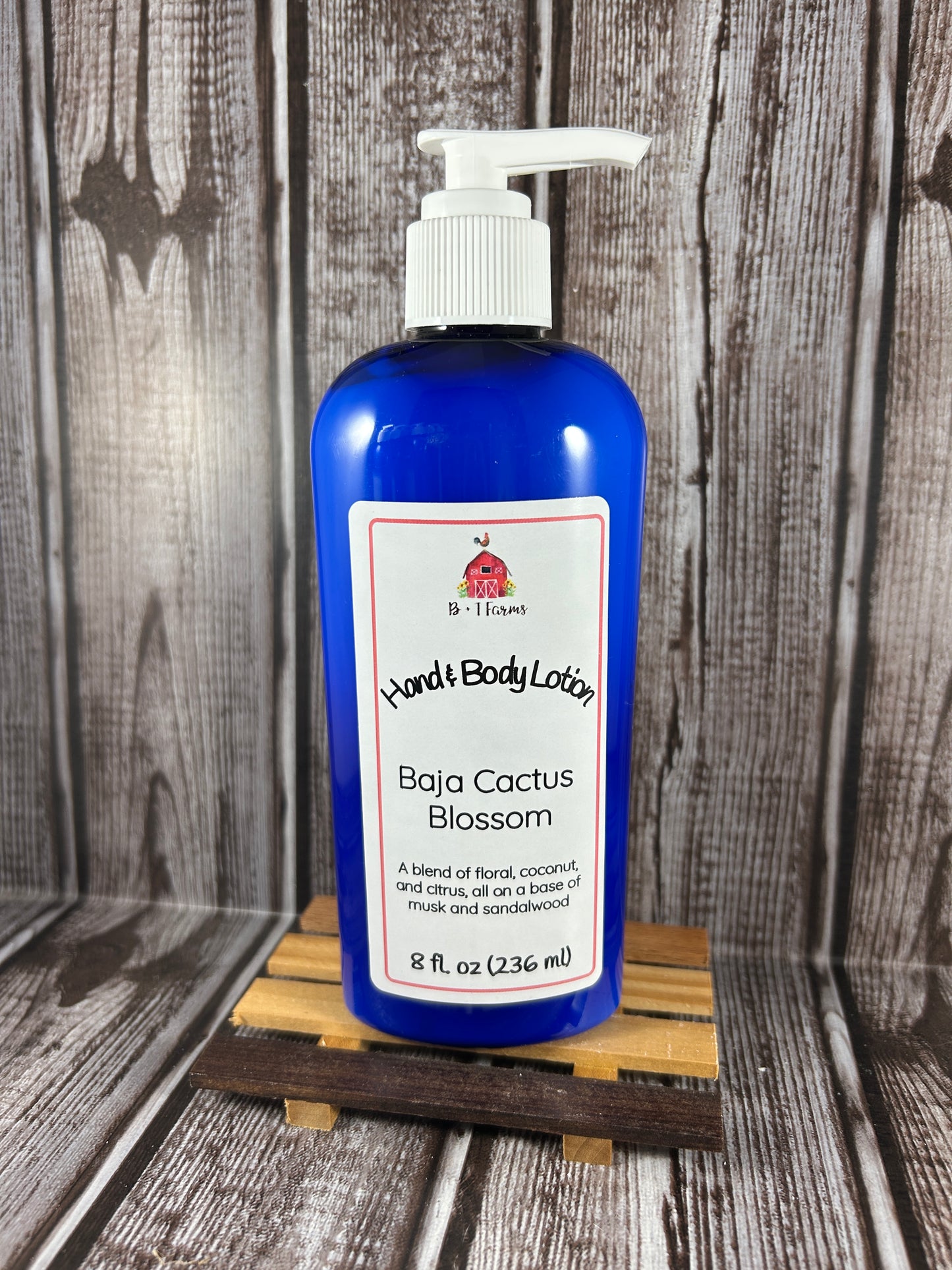 Hand and body lotion bottle on a wooden surface. Scent is called Baja Cactus Blossom