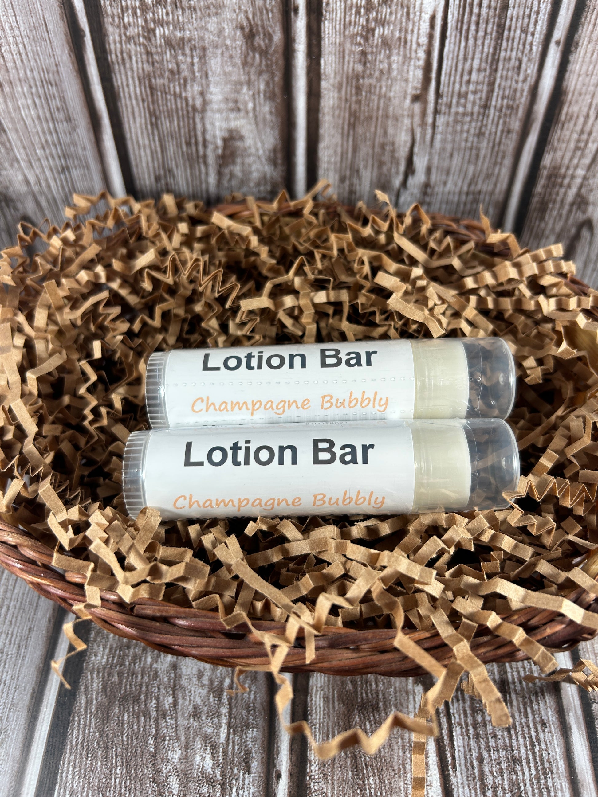 Two lotion bars in a decorative basket on a wooden surface